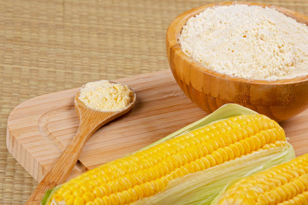 istock Wooden bowl of cornmeal or cornflower wirh corncobs 1272972037