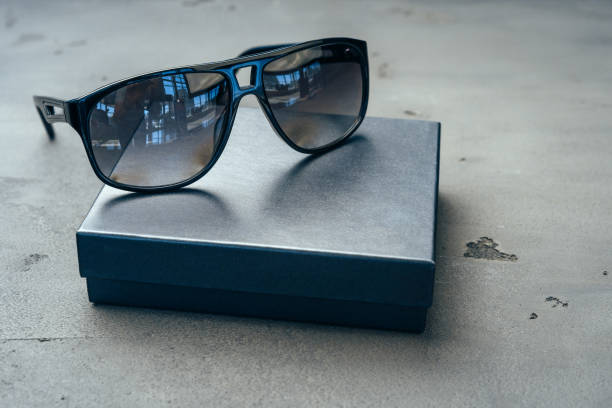 Dark male sunglasses on grey concrete surface