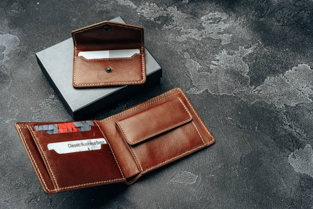 istock New brown leather wallet on dark background 1272972740