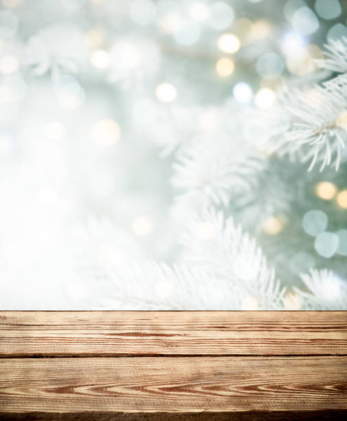 istock Christmas tree branches with wooden background 1272973004