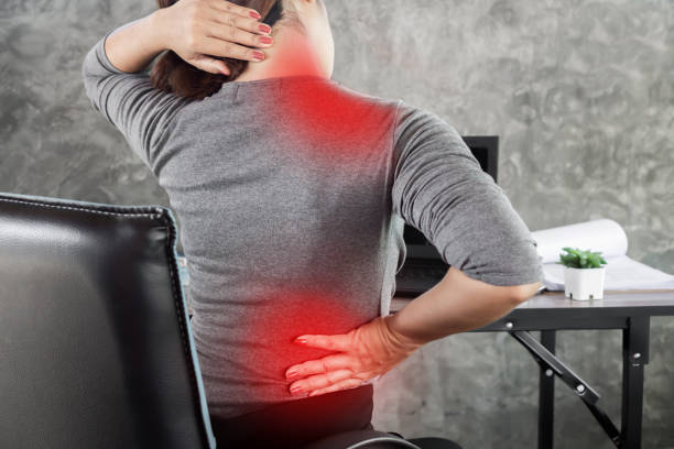 woman suffering from office syndrome having lower back pain, neck and shoulder pain sitting on chair Asian woman suffering from office syndrome having lower back pain, neck and shoulder pain sitting on chair office back pain stock pictures, royalty-free photos & images