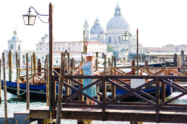 travel tourist woman with backpack in venice, italy. girl on vacation smiling happy by grand canal. girl having fun traveling outdoors. - travel outdoors tourist venice italy imagens e fotografias de stock