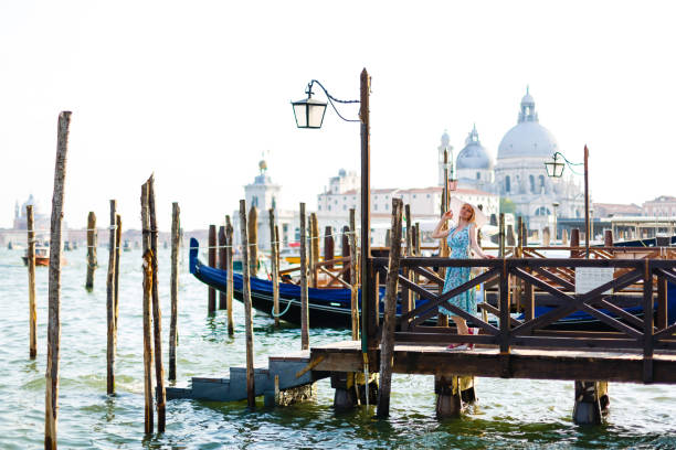 travel tourist woman with backpack in venice, italy. girl on vacation smiling happy by grand canal. girl having fun traveling outdoors. - travel outdoors tourist venice italy imagens e fotografias de stock