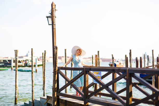 travel tourist woman with backpack in venice, italy. girl on vacation smiling happy by grand canal. girl having fun traveling outdoors. - travel outdoors tourist venice italy imagens e fotografias de stock