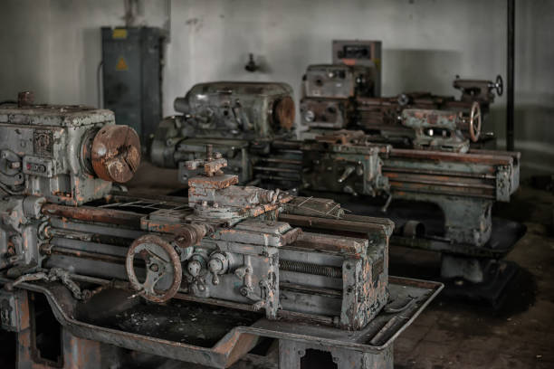 istock Old broken rusty lathes in the workshop of an abandoned factory 1272976409