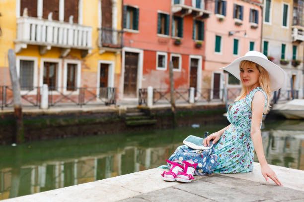 travel tourist woman with backpack in venice, italy. girl on vacation smiling happy by grand canal. girl having fun traveling outdoors. - travel outdoors tourist venice italy imagens e fotografias de stock