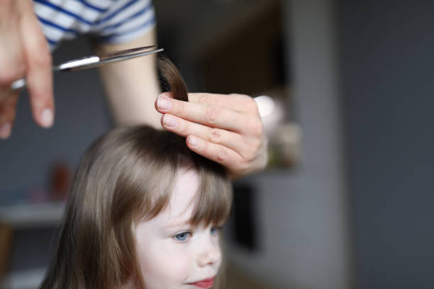 Mom cuts hair at home child during quarantine closed all hairdressers. Domestic lifestyle on covid 19 time concept