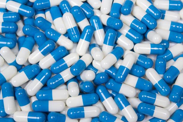 istock close up of blue and white capsules - background 1272976953
