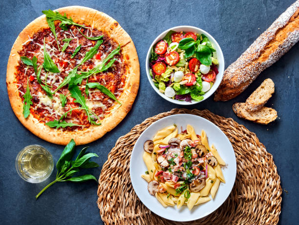 istock pizza with salat and pasta ready to eat on a stone undergound. 1272977103