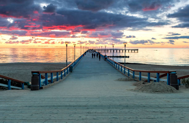 istock Colorful sunset on walking marine pier, Baltic Sea 1272977889