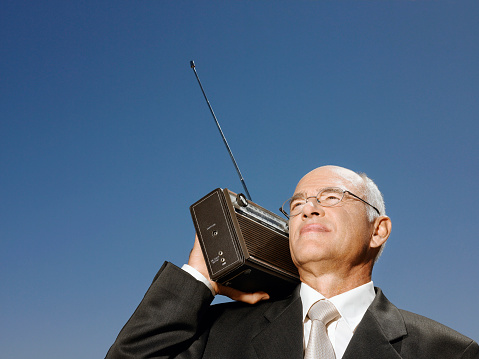 Businessman with radio on shoulder head and shoulders
