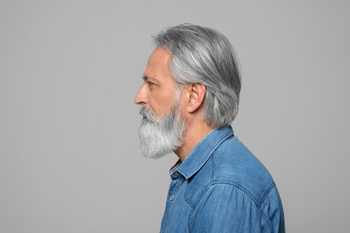 Close up indoors portrait of a happy 50 year old man