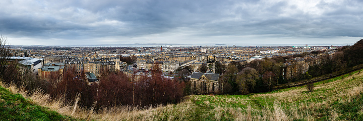 City panorama from the hill of Edinburgh, Scotland, UK under a cloudy sky