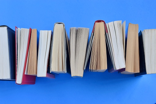 Stack of books on the blue background