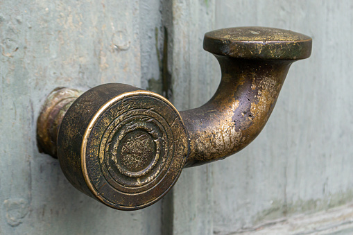 close-up of an old door handle. the metal door handle with traces of patina