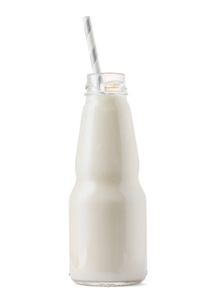 istock Glass cup of milk with a straw isolated on white 1272982067