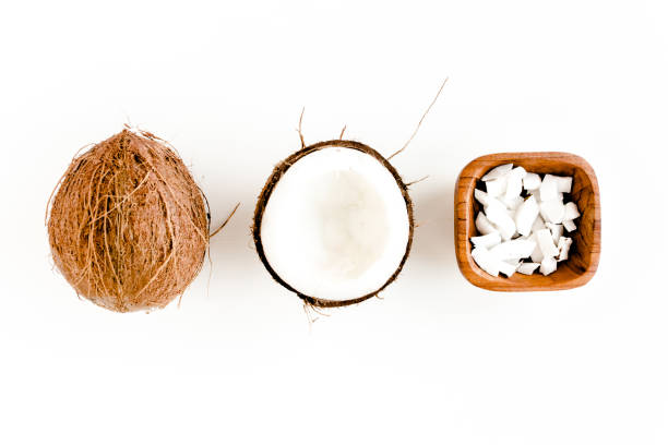 istock Pattern with coconuts and tropical palm leaves on white background. Tropical abstract background. Flat lay, top view 1272984669