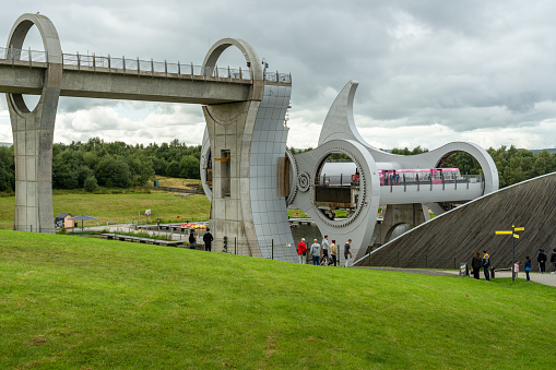 Falkirk, Scotland - August 23, 2020: The Falkirk Wheel - world's only rotating boat lift connecting the Forth & Clyde Canal and the Union Canal. Scottish landmark attracting over 500,000 visitors a year