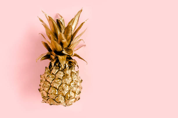 istock Top view golden pineapple isolated on pink background with copy space for text. Template blog social media. Food concept. Minimal style. flat lay 1272985199