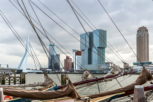 Old and new.  Rotterdam city skyline cityscape, Netherland (Holland). View of downtown and sailing ship with the flag from Veerhaven