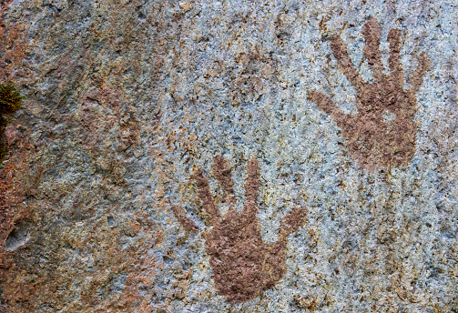 Human hand prints painted on stone surface