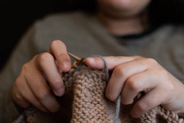istock Close-up of a hand holding knitting needles 1272987769
