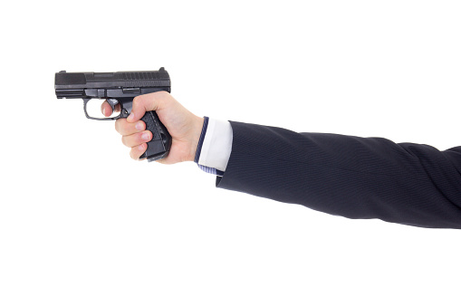 male hand in business suit with gun isolated on white background