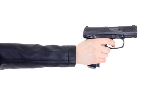 gun in female hand isolated on white stock photo