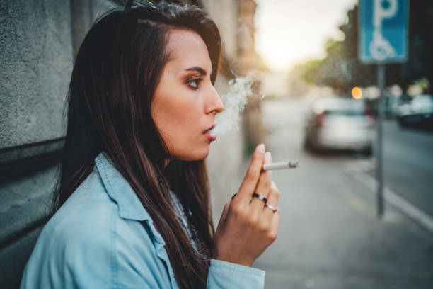 istock Young woman enjoying a cigarette 1272990369