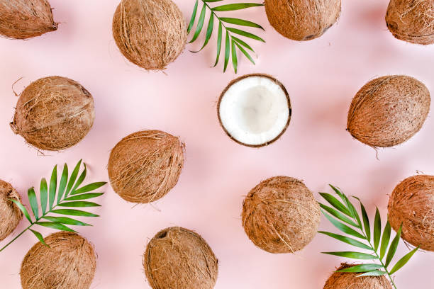 istock Pattern, texture with coconuts and tropical palm leaves on pink background. Tropical abstract background. Flat lay, top view 1272990463