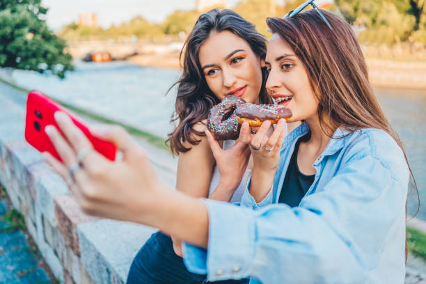 istock Women with donuts taking selfie 1272991060
