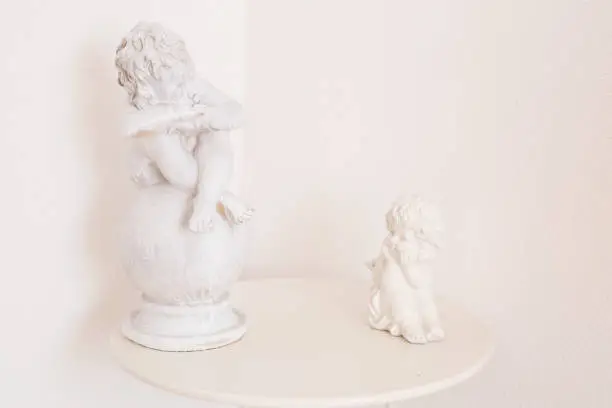 Photo of figurine and interior concept - white ceramic angel