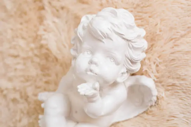 Photo of figurine and interior concept - white ceramic angel