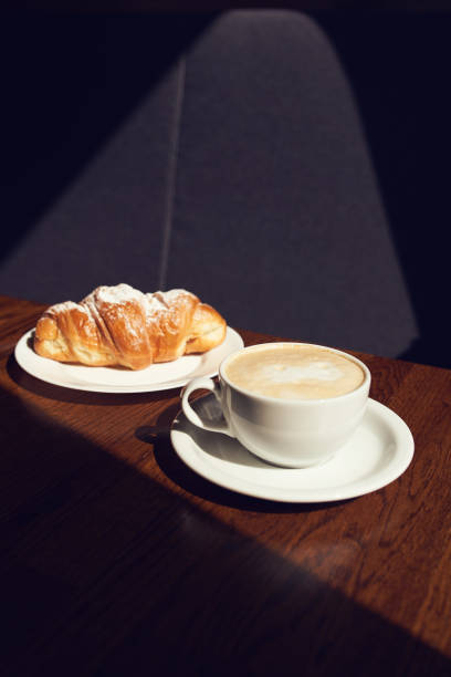 istock Cappuccino with latte art and croissant 1272992363