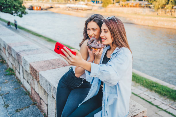 istock Women with donuts taking selfie 1272992445