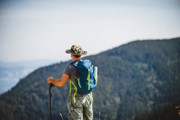 istock Man taking a break from his hike on a sunny day for breathtaking views 1272993350