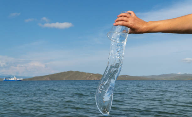 istock clean water flows from a plastic Cup. selective focus. water splash on a natural background 1272993386