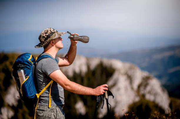 istock Man taking a break from his hike on a sunny day for breathtaking views 1272993749