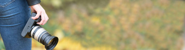 istock A woman with a camera in the park 1272996072