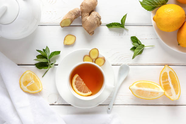 istock Antioxidant healthy tea with lemon, ginger and mint on a white wooden table. Alternative medicine concept. 1272998024