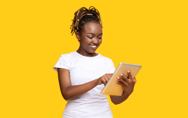 istock Pretty african girl with digital tablet, using new app 1273001641