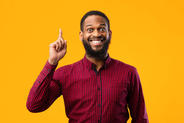 istock Excited black man having great idea and pointing up 1273002010
