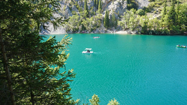istock Mountain lake Kolsay with floating boats 1273003468