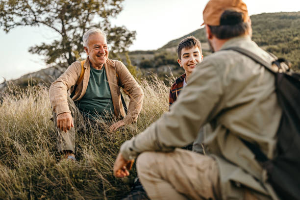 istock Three generations males relaxing on hiking tour 1273003651