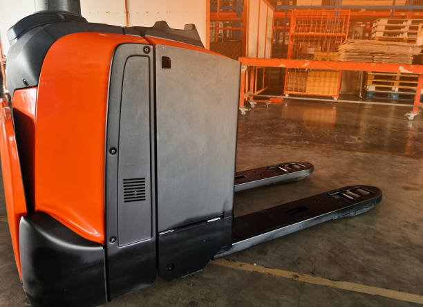 istock Worker driving forklift loading shipment carton boxes goods on wooden pallet at loading dock from container truck to warehouse cargo storage in freight logistics, transportation industrial, delivery 1273003919