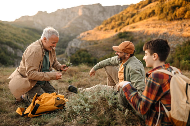 istock Three generations males with herbs on hiking tour 1273005093