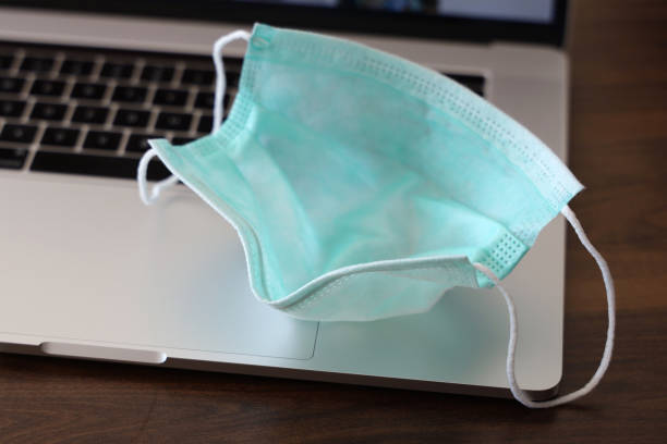 istock Medical face mask on laptop 1273005113
