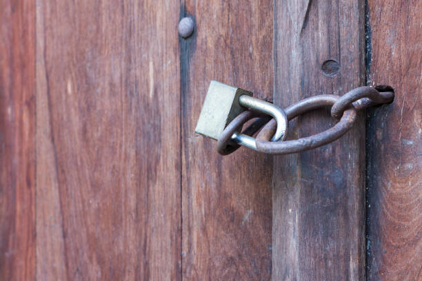istock Lock key on old wooden door. 1273005230