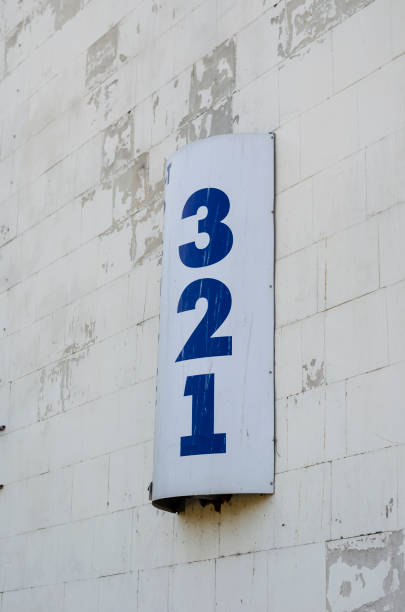 Semicircular sign on the wall with numbers 3,2,1.
