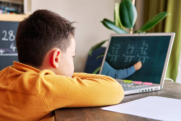 istock 6-7 years cute child learning mathematics from computer. Learning at home. 1273006860